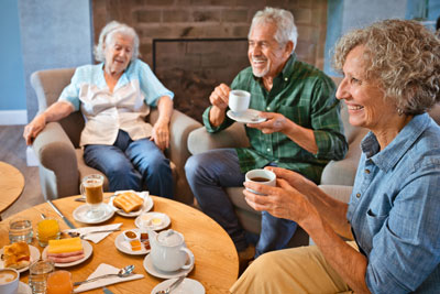 Group of elderly people having coffee and talking.